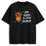 Czarna koszulka z ilustracją kapibary w słuchawkach i kolorowymi gwiazdkami, w stylu K-pop kawaii.